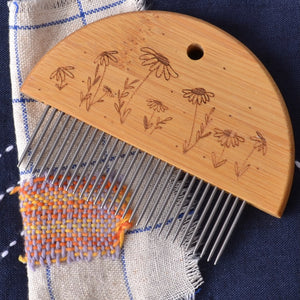 mending loom comb with daisy pattern